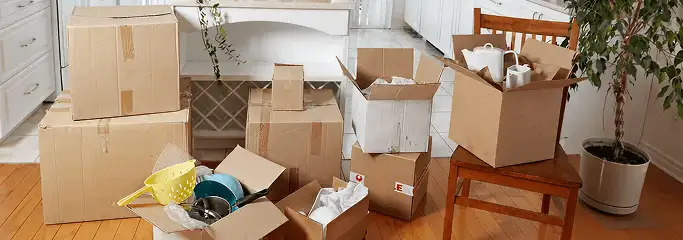 Packed moving boxes and household items in a kitchen before move-out or move-in cleaning, Boulder, CO.